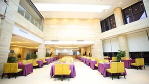 A spacious indoor area with multiple tables and chairs, arranged in rows, likely for dining or events. - Sumahui Hotel (Suzhou East Railway Station Kechuang Center) (Suzhou)