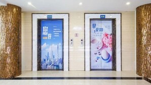 Two elevator doors with advertisements, one featuring a cityscape and the other with floral imagery. - Shiman Art Hotel (Guangzhou Chebei Subway Station) (Guangzhou)