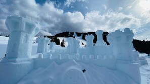 A snow sculpture of a castle with a moat and towers. - Rainier Retreat close to White Pass (Packwood)