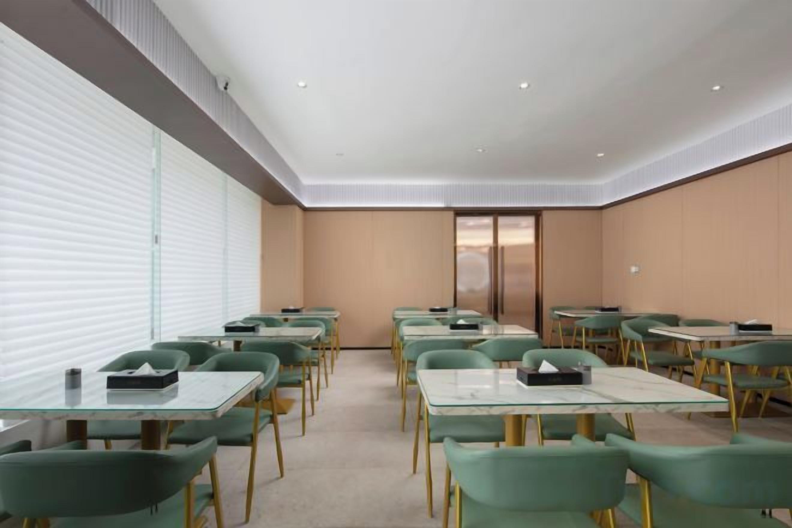 A conference room with tables and chairs arranged for meetings.