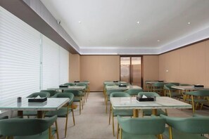 A conference room with tables and chairs arranged for meetings.