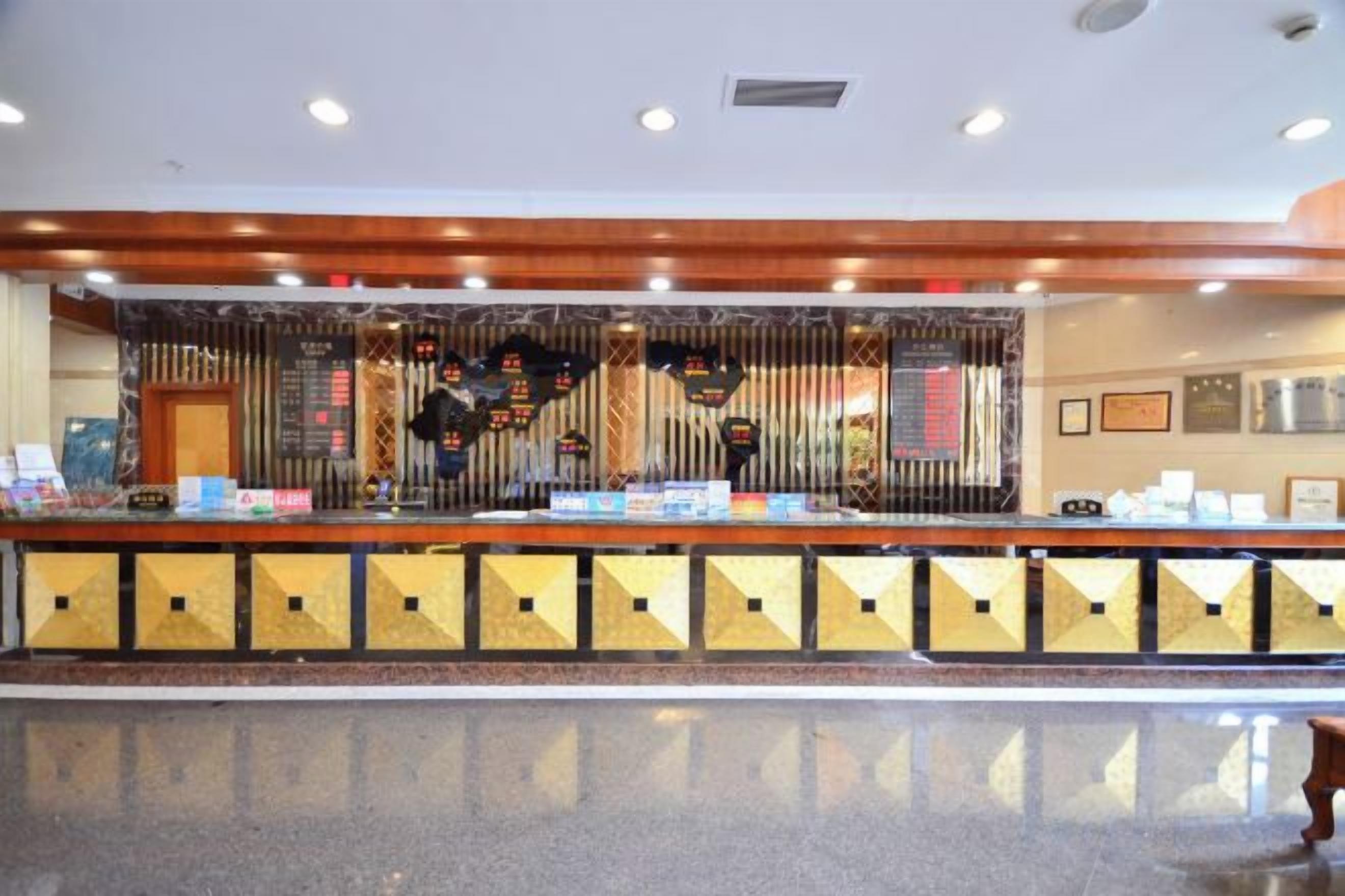 A reception desk with a counter, a cash register, and a display of items.
