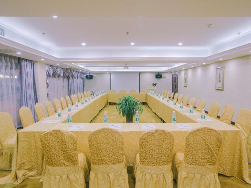 A conference room with a long table, chairs, and nameplates.