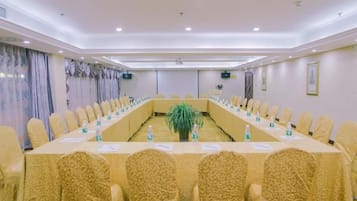 A conference room with a long table, chairs, and nameplates.