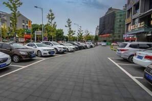 A parking lot with multiple rows of parked cars. - City Garden Hotel Chain (Chizhou Vocational College Xiushanmen Millennium Ancient City Building ) (Chizhou)