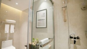 A modern bathroom with a glass-enclosed shower, a toilet, and a towel rack. - GYA Hotel (Yancheng Wengang Road High-speed Railway Station) (Yancheng)