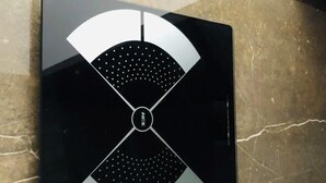 A black and white logo with a central circular element and four symmetrical sections. - Xinshenghao Hotel (Chengdu)
