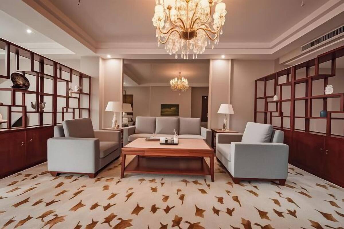 A modern living room with a sofa set, a coffee table, and decorative lighting.