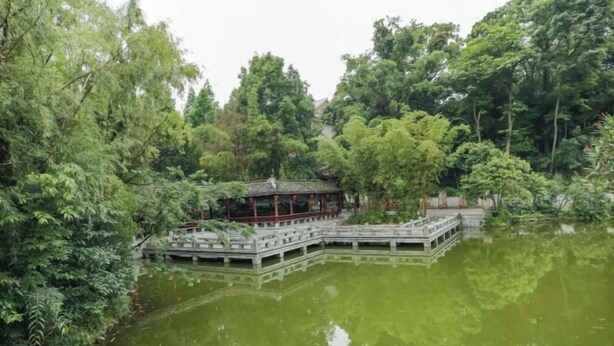 A traditional Chinese pavilion over a pond, surrounded by lush greenery. - Kester Business Hotel (Qianxi)