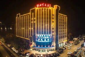 A multi-story hotel with a prominent entrance and signage.