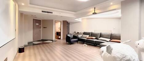 Una sala de estar moderna con un sofá modular, una mesa de centro y una lámpara grande.