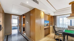 A modern hotel room with a wooden wardrobe, a television, a pool table, and a view of the outdoors. - Foshan Star Hotel (Huili Plaza Store) (Foshan)