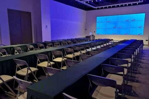 A conference room with a long table, chairs, and a presentation screen. - Xunwu Hotel (Xunwu)