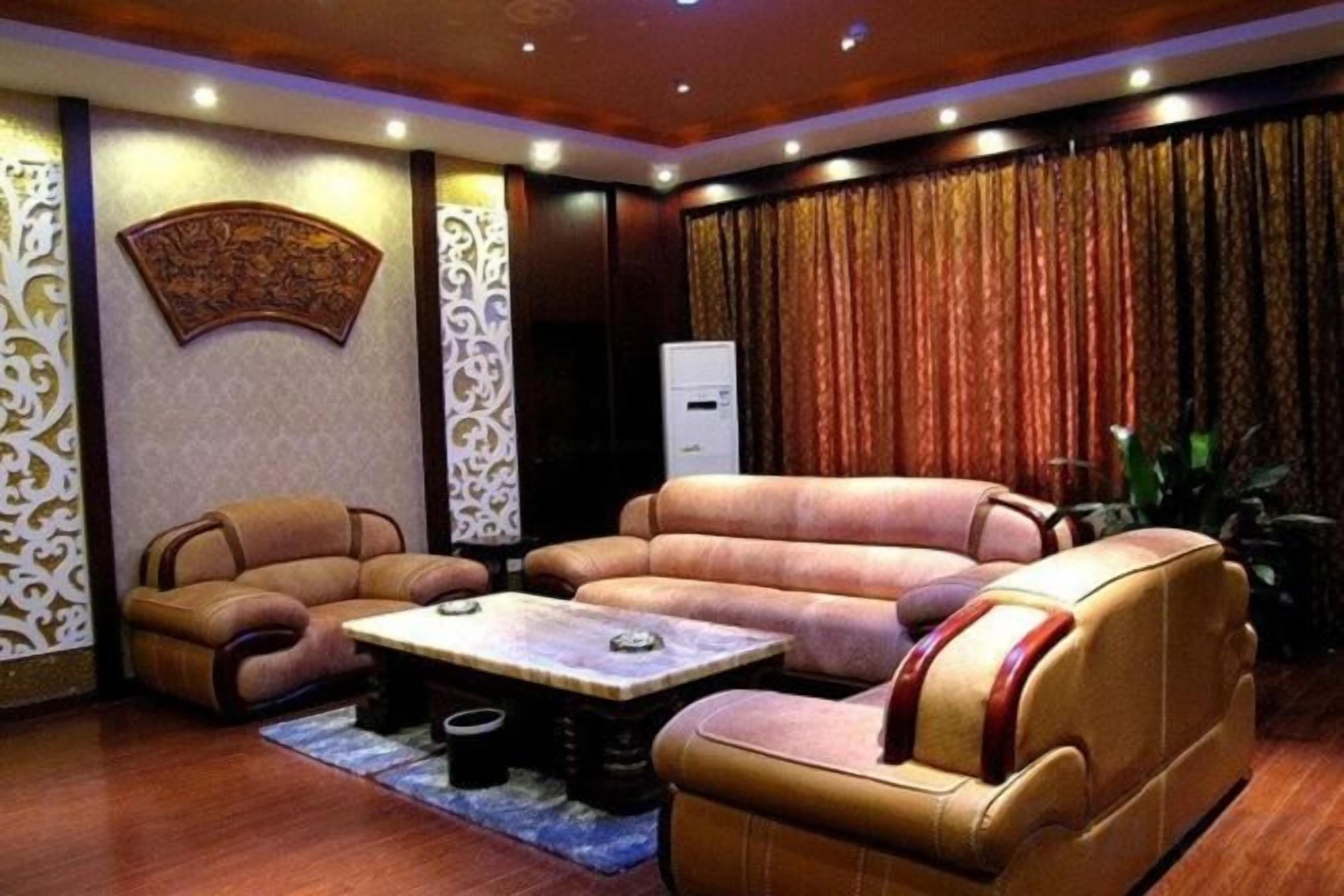 A living room with a sofa set, a coffee table, and a decorative wall piece.