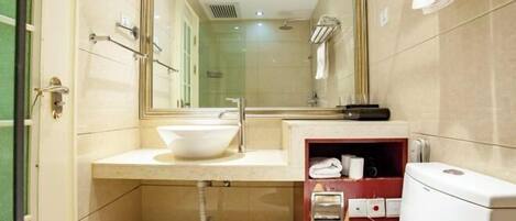 A modern bathroom with a glass-enclosed shower, a white sink, and a toilet.