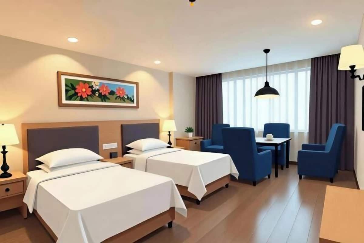 A hotel room with two beds, a desk, chairs, a painting, and a window with curtains.