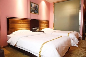 A hotel room with two beds, a wooden headboard, a painting on the wall, and a large window. - Duxiu Hotel (Tacheng City)