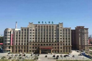A large, multi-story building with a central entrance and a sign above. - Duxiu Hotel (Tacheng City)