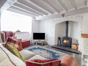 A cozy living room with a fireplace, a flat-screen TV, and comfortable seating. - 1 Hendom (Corwen)