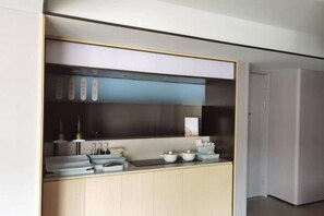 A modern kitchen with a built-in stove, a microwave, and a range hood.