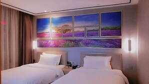 A hotel room with two beds, a large wall art piece, and a nightstand with a phone. - Lavande Hotel (Longnan Changjiang Avenue) (Longnan)