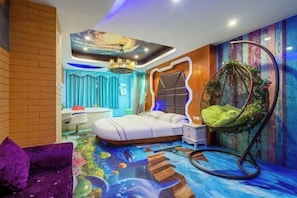 A bedroom with a bed, a hanging chair, a ceiling mural, and a colorful floor design. - Valatoms Fanlatu Hotel (Shuifu Municipal Government) (Shuifu)
