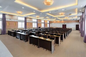 A conference room with rows of tables and chairs, large windows, and a modern chandelier. - Valatoms Fanlatu Hotel (Shuifu Municipal Government) (Shuifu)
