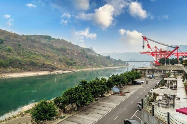 A riverside view with a road, trees, and a crane. - Valatoms Fanlatu Hotel (Shuifu Municipal Government) (Shuifu)