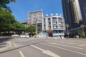 A hotel with a modern design, featuring a prominent sign and a curved facade. - Valatoms Fanlatu Hotel (Shuifu Municipal Government) (Shuifu)