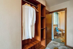 A walk-in closet with wooden shelves and a hanging rack. - Valatoms Fanlatu Hotel (Shuifu Municipal Government) (Shuifu)