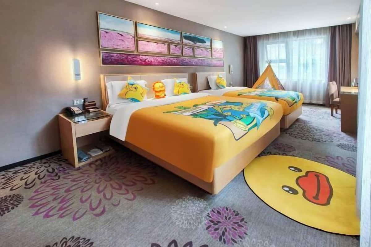 A hotel room with a large bed, a bedside table, a chair, and a window with curtains.