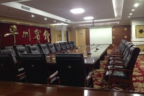 A conference room with a long table, leather chairs, and a red carpet. - Pingchuan Hotel (Baiyin)