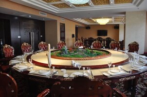 A conference room with a round table, chairs, and a decorative centerpiece.