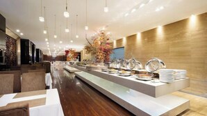 A buffet area with multiple serving stations, a long counter, and overhead lighting. - Apollo Regalia Hotel & Resort (Yueyang)