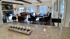 A spacious living area with a fireplace, a dining table, and comfortable seating. - Ideally Located, Sun Valley Chalet (Ketchum)