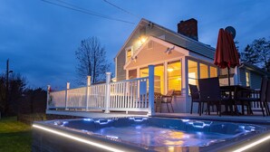Une maison avec un jacuzzi et une terrasse.