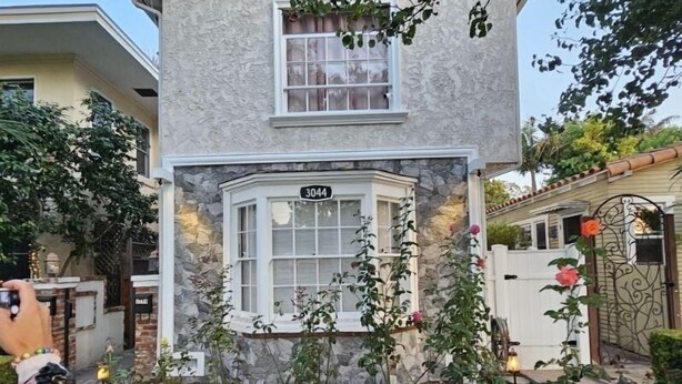 A house with a stone facade, a bay window, and a number '3044' displayed above the window. - Cute Tropical Beach Studio Walk to Ocean and All! (Long Beach)