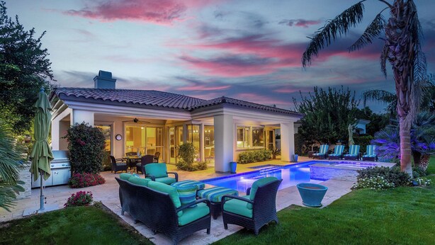 A modern house with a swimming pool, outdoor furniture, and lush landscaping. - Villa Del Sol - 3 Suites w/ Pool, Spa, Firepit (La Quinta)