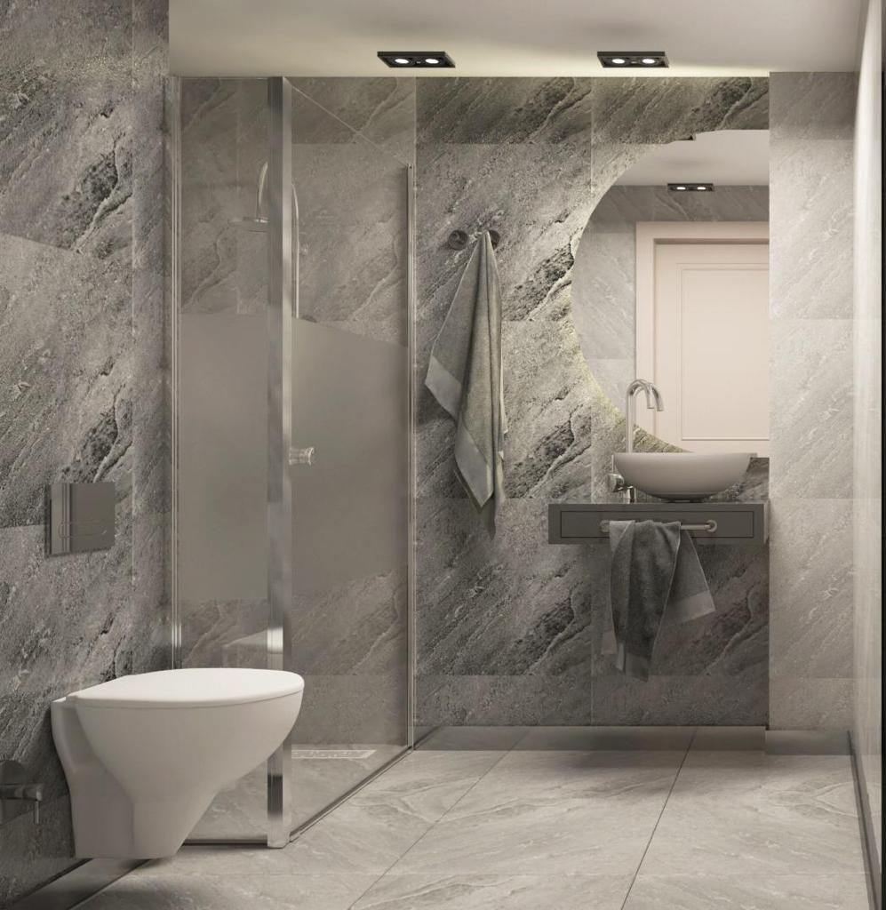 A modern bathroom with a glass shower enclosure, a toilet, and a sink with a mirror.