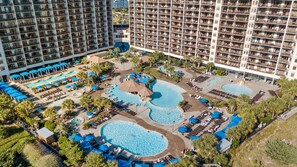 A hotel with multiple swimming pools, sun loungers, and umbrellas. - $150 activities - E-gift card when you book - Beautiful Oceanfront | Indoor/Outdoor Pools | NBP1916 (North Myrtle Beach)