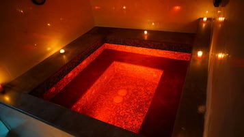 Relax in a hot tub surrounded by a warm ambiance.