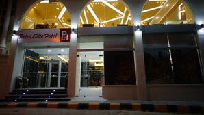 The exterior of Petra Elite Hotel with a modern design, featuring arched windows and a prominent entrance. - Petra Elite Hotel (Wadi Musa)
