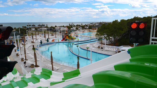 A water park with multiple pools, slides, and a view of the ocean. - 5-Star Lakefront Beach House in Ocean Lakes (Myrtle Beach)