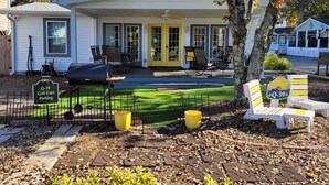 A house with a porch, outdoor seating, a grill, and a golf cart parking sign. - 5-Star Lakefront Beach House in Ocean Lakes (Myrtle Beach)