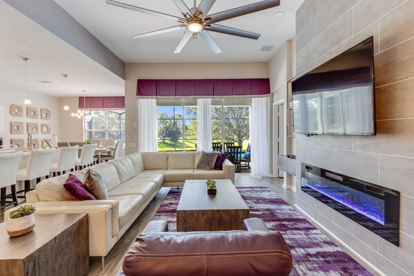 A modern living room with a sofa, coffee table, and fireplace.