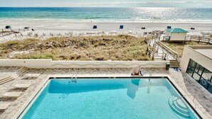 A swimming pool with a view of the beach and ocean.