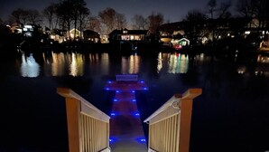 A wooden staircase leading to a dock over water, with houses in the background. - Lakeside Home w/Lake Access, Dock & Water Views! (Hopatcong)