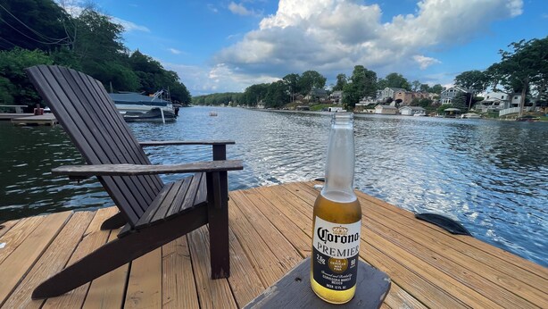 A wooden dock with a chair and a bottle of Corona Premier beer. - Lakeside Home w/Lake Access, Dock & Water Views! (Hopatcong)