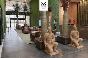 Relax in our spacious lobby with leather sofas and armchairs, surrounded by unique terracotta warrior statues and lush artificial grass walls.