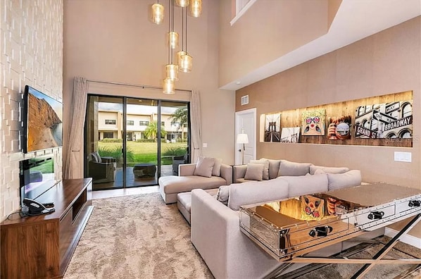 Relax in this stylish living room with a large sofa, flat-screen TV, and coffee table storage.